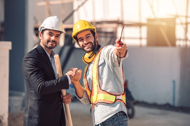 happy-workers-construction-site-young-civil-engineer-manager-architects-handshaking-construction-site-looking-construction-phase-cooperation-teamwork-concept_640221-293
